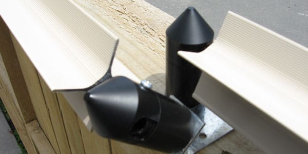 Oscillot on brackets (left) transitioning to Oscillot on top, in order to allow room for a gate to open against the fence.